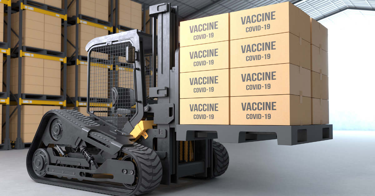 A robotic forklift loaded with boxes of COVID-19 vaccine stands in a warehouse.