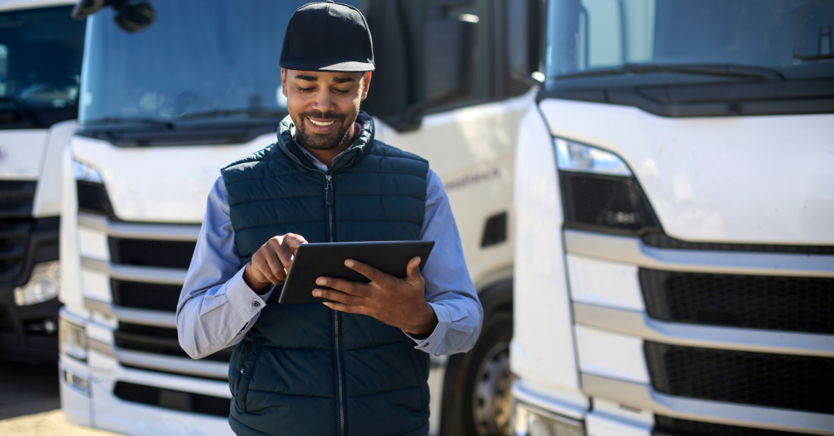 A truck driver using a tablet to log hours of service for fleet management